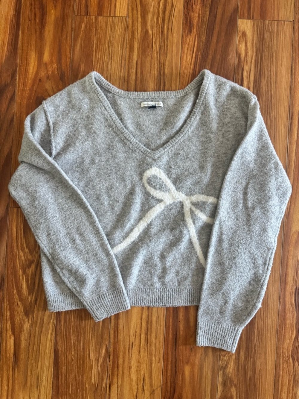 American Eagle Outfitters Light Gray V-Neck Sweater with Cream Bow Detail